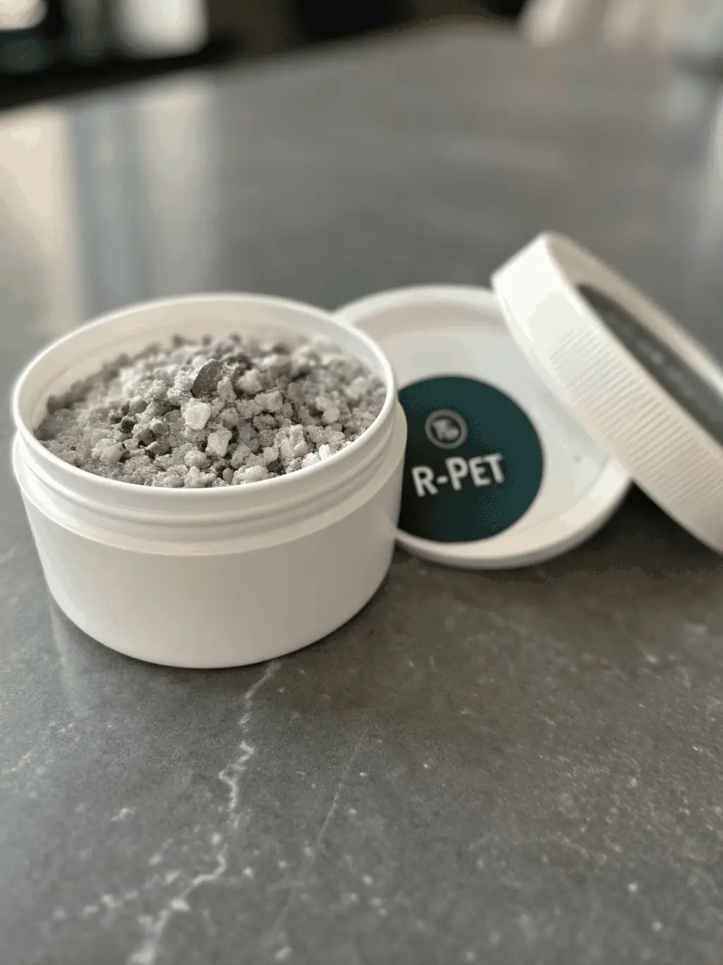 A close-up image of R-PET flakes being produced, highlighting their clarity and purity, demonstrating the quality of RePlastic Global's recycled materials.